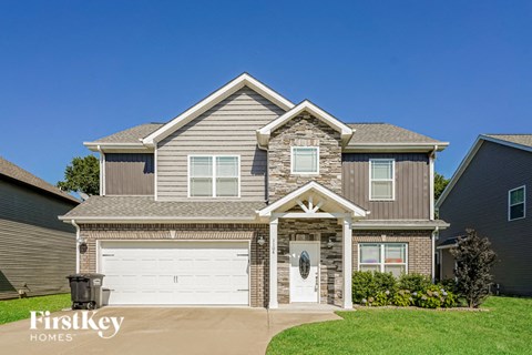 a large suburban house with a white garage door
