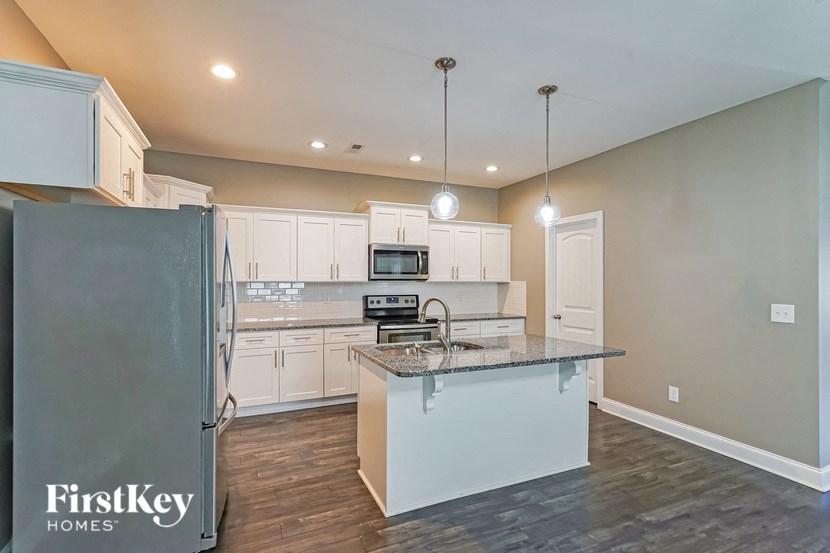 a kitchen with white cabinets and a counter top