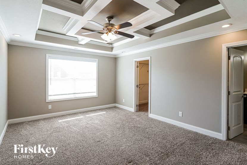 a bedroom with a ceiling fan and a closet