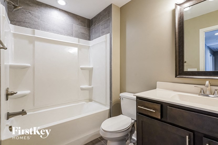 a bathroom with a toilet and a sink and a bath tub