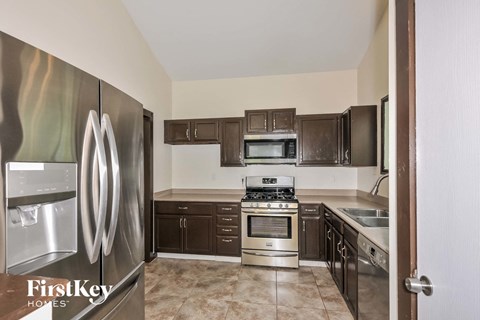 A kitchen with a stainless steel refrigerator and oven.