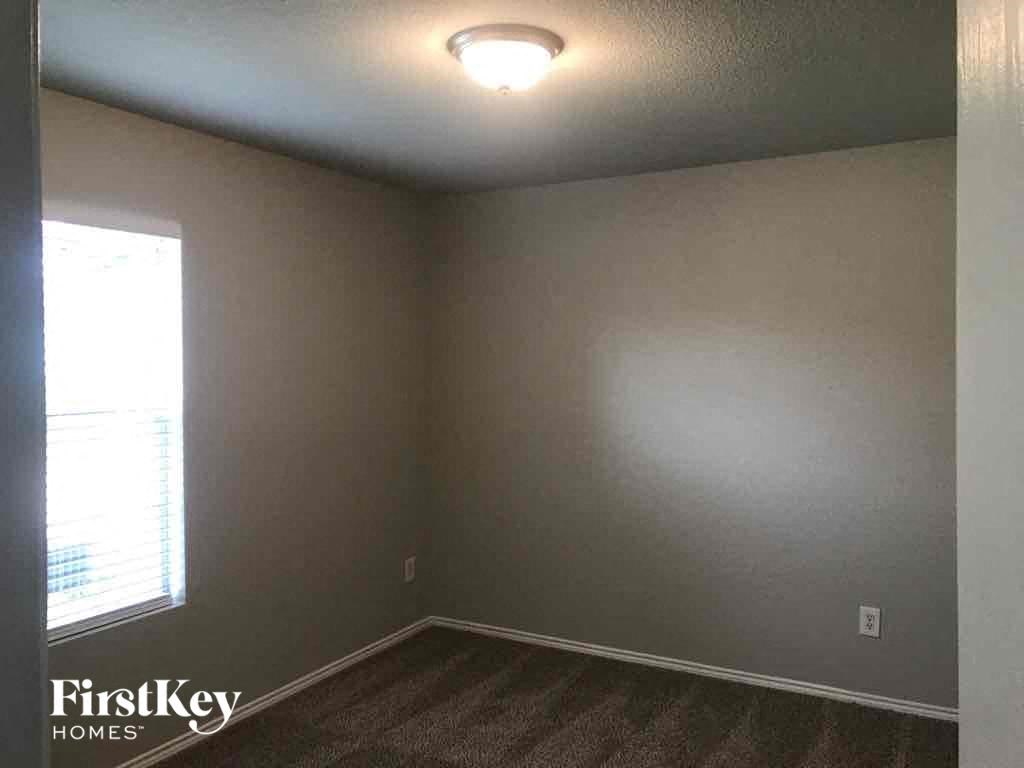 an empty room with a white wall and a window