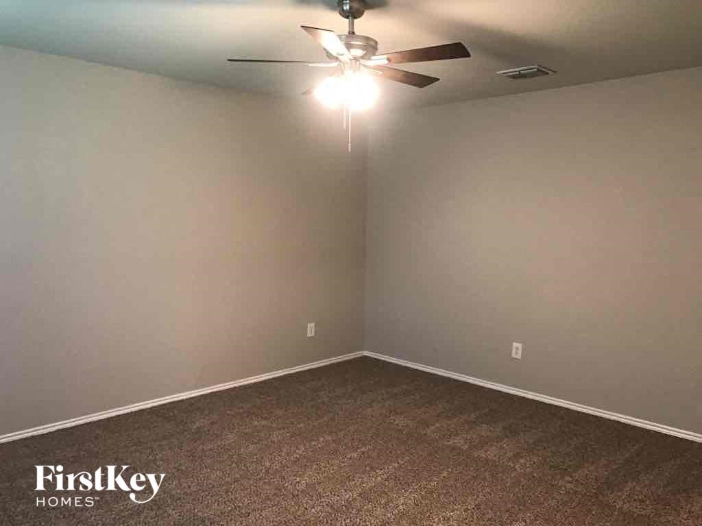 a empty white room with a ceiling fan