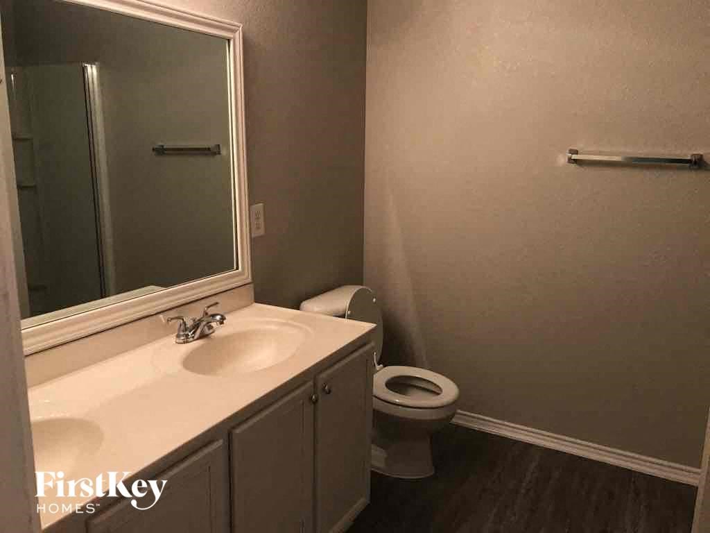 a bathroom with a sink and a toilet and a mirror
