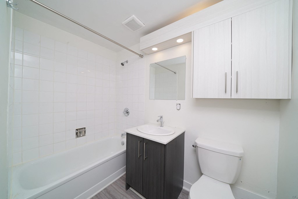 a bathroom with a toilet sink and bath tub
