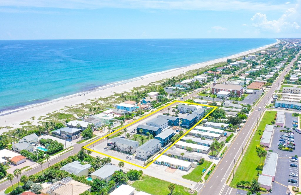 an aerial view of a beach with houses and the ocean