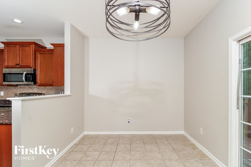 A well-lit empty room with a FirstKey Homes logo.