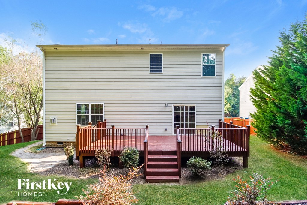 A house with a deck and a small garden.