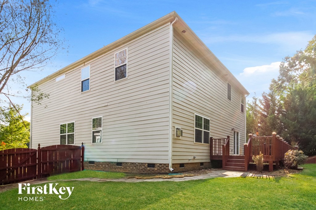 A house with a fence and a small porch.