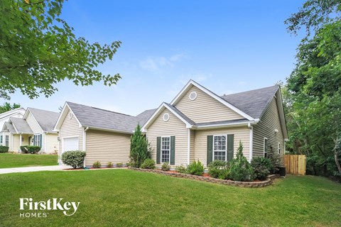 a home with a green lawn and a yard with trees
