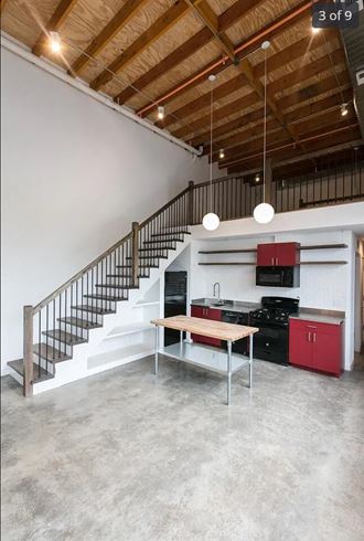 a kitchen with a table and a staircase in a loft