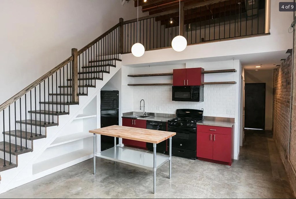 a small kitchen under a staircase in a house