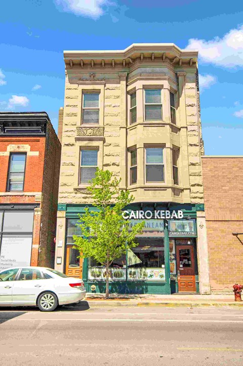 a white car parked in front of a building on a city street