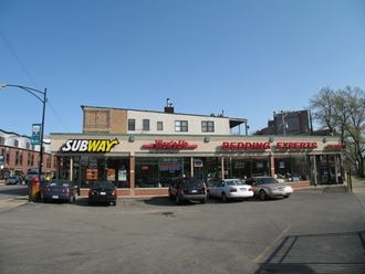 a subway store on the corner of a city street