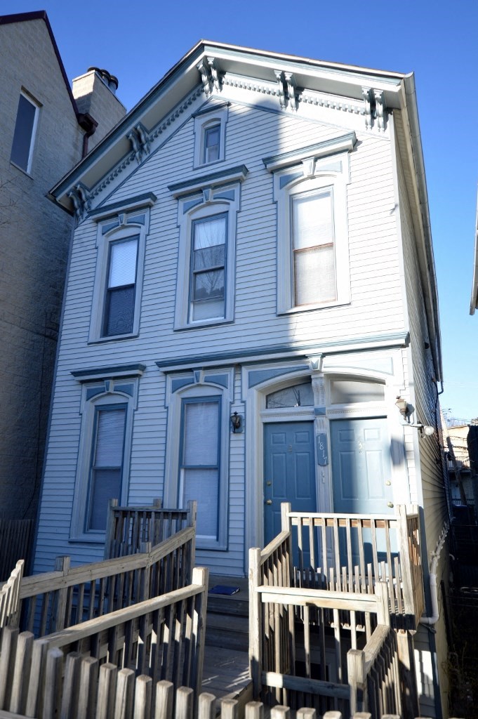 a white house with a blue door and stairs