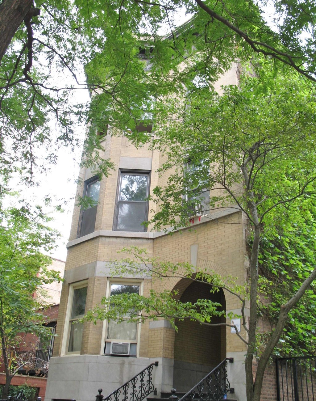 a tall building with trees in front of it