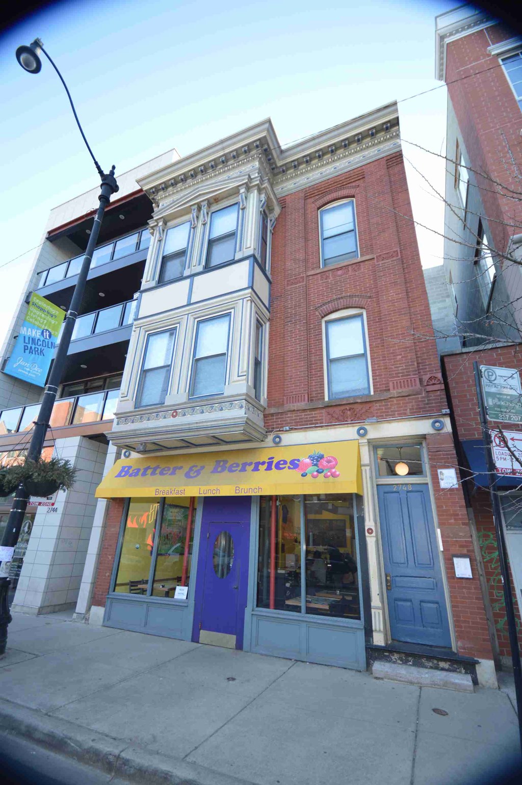 a building with a blue door and a yellow sign on the front of it