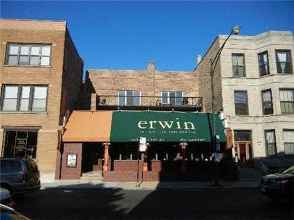 a building with a green sign on the front of it
