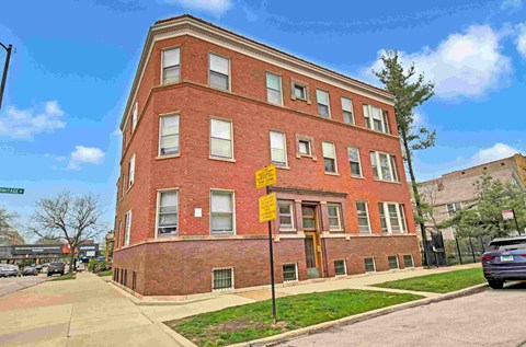 a red brick building on the corner of a street