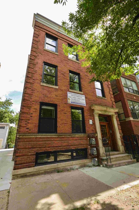 a red brick building with a sign on the side of it