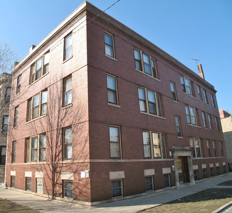 a red brick building on the corner of a street