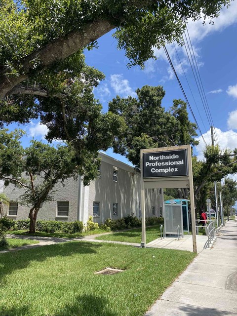 A sign for the Northside Professional Complex stands in front of a building.