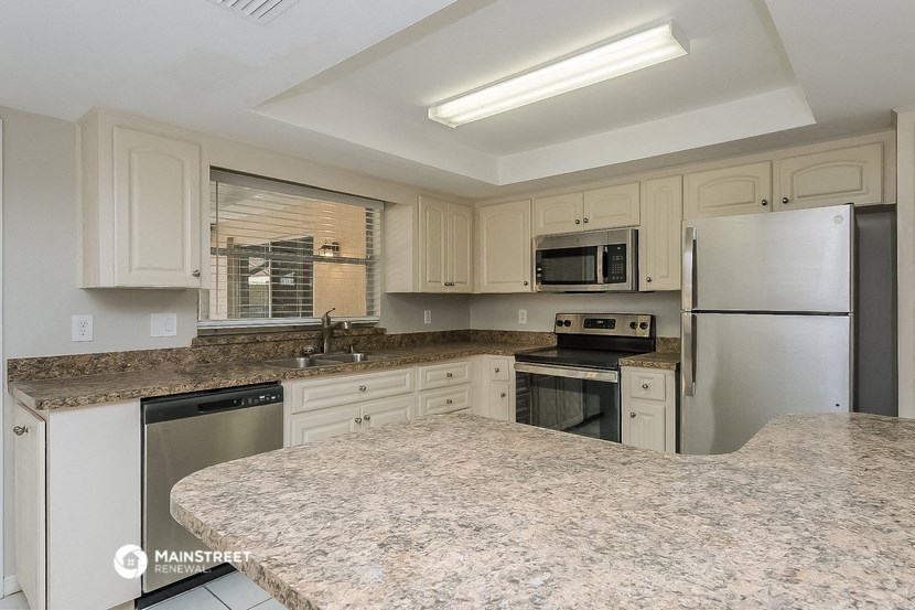 a kitchen with granite counter tops and stainless steel appliances