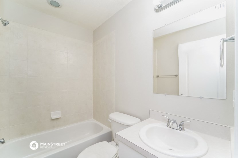 a bathroom with a sink toilet and a bath tub