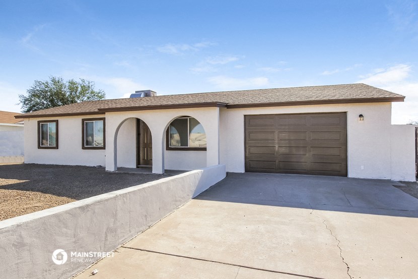 a white house with a garage and a driveway