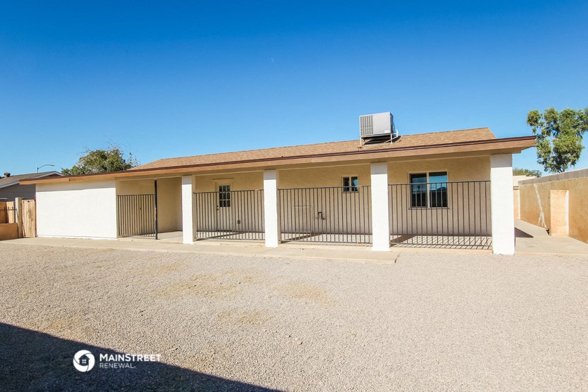the front of a house with a gate