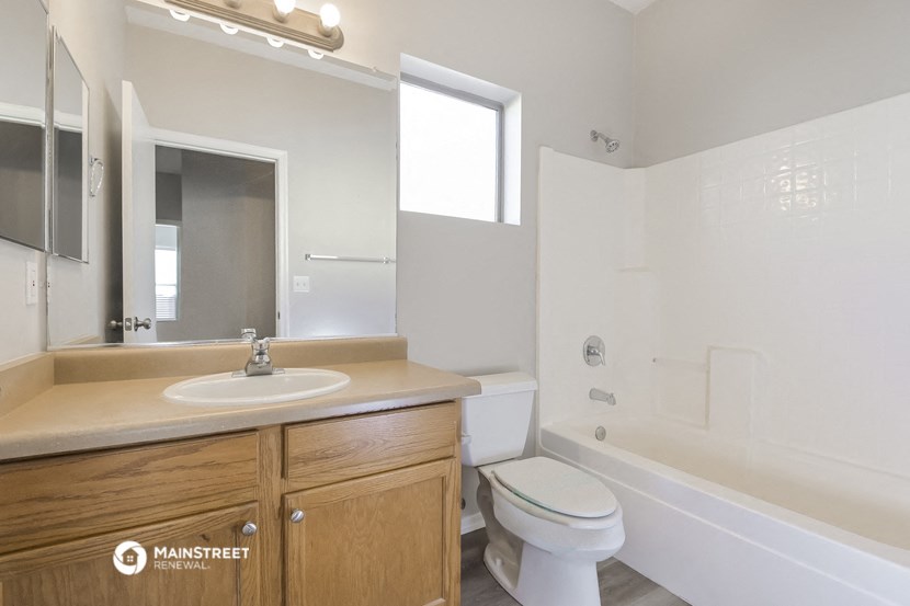 an empty bathroom with a sink toilet and tub