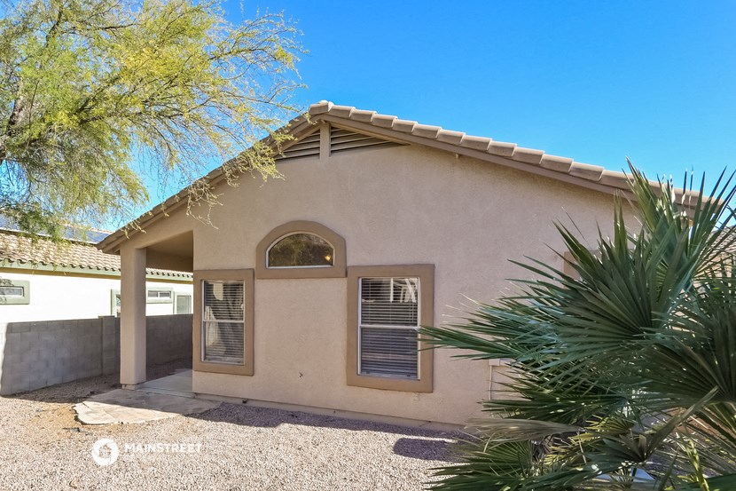 a small house with a palm tree in front of it