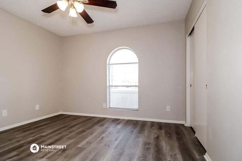 the spacious living room with a large window overlooking the water