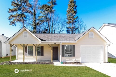 a cream colored house with a white garage door