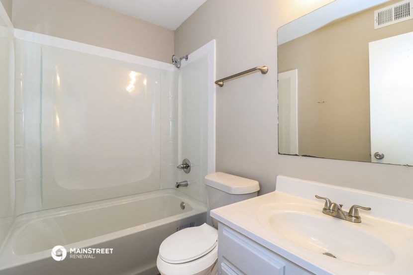 a bathroom with a sink toilet and a shower