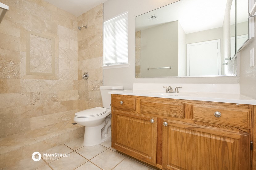 a bathroom with a toilet and a sink and a mirror
