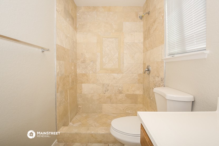 a small bathroom with a toilet and a shower