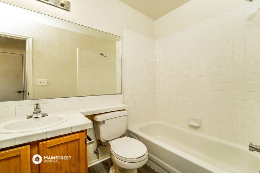 a bathroom with a sink toilet and a bath tub