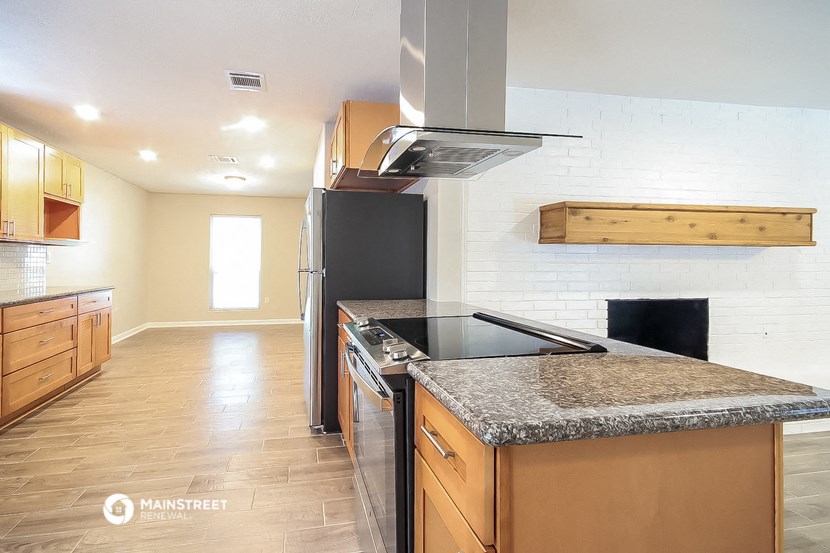 a kitchen with stainless steel appliances and granite counter tops