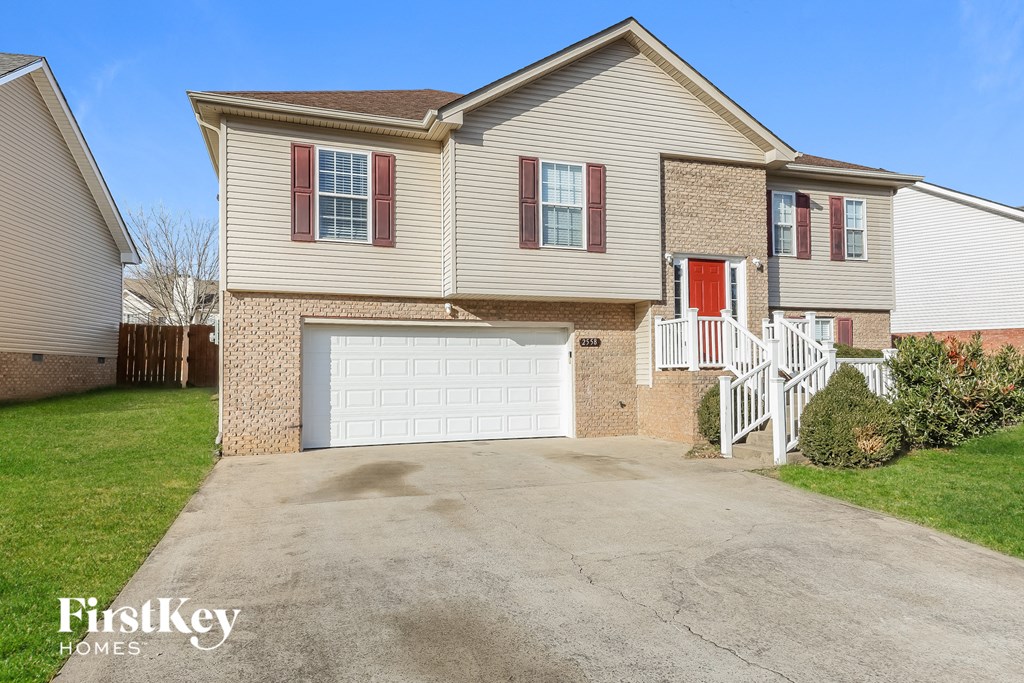 a large house with a white garage door on a driveway