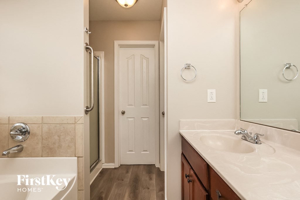 a bathroom with a shower and a sink and a mirror