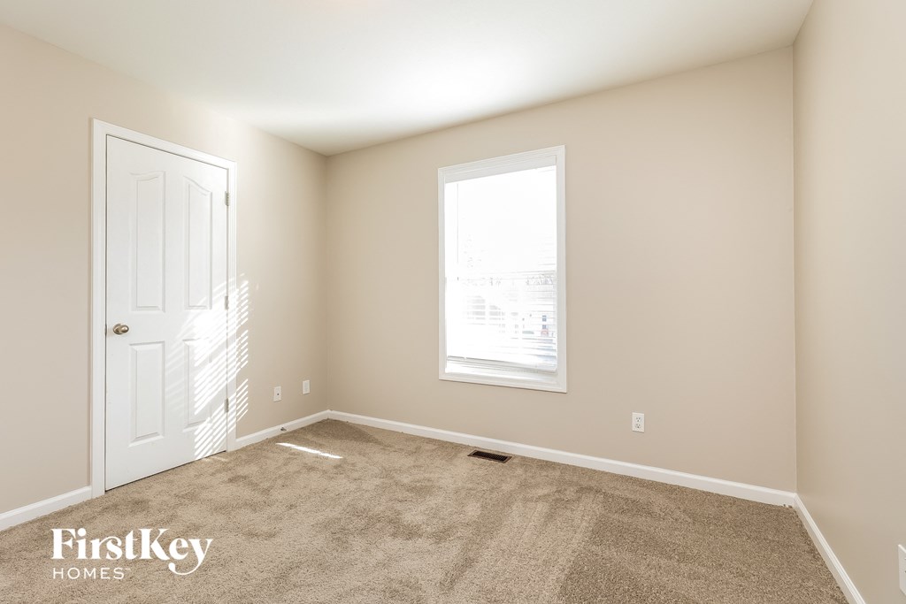 a empty room with a door and a window