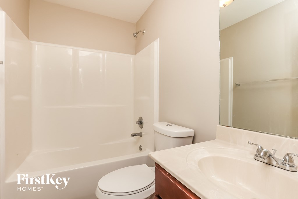 a bathroom with a toilet and a sink and a shower