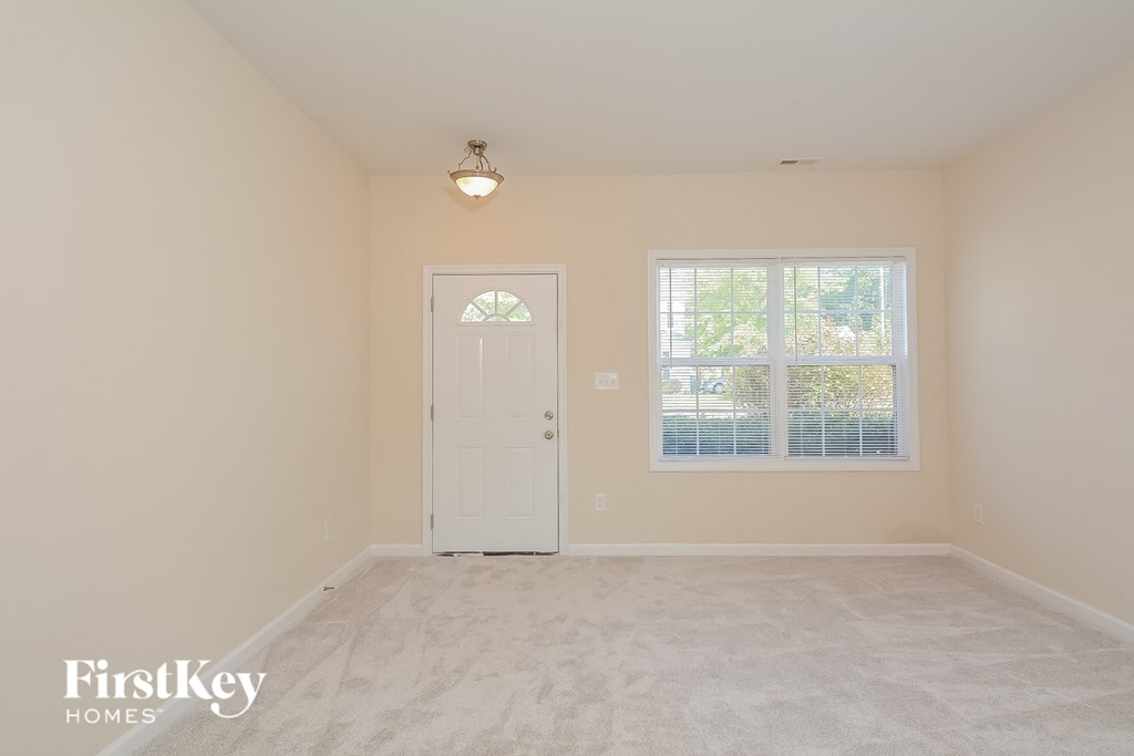 a bedroom with a white door and a window