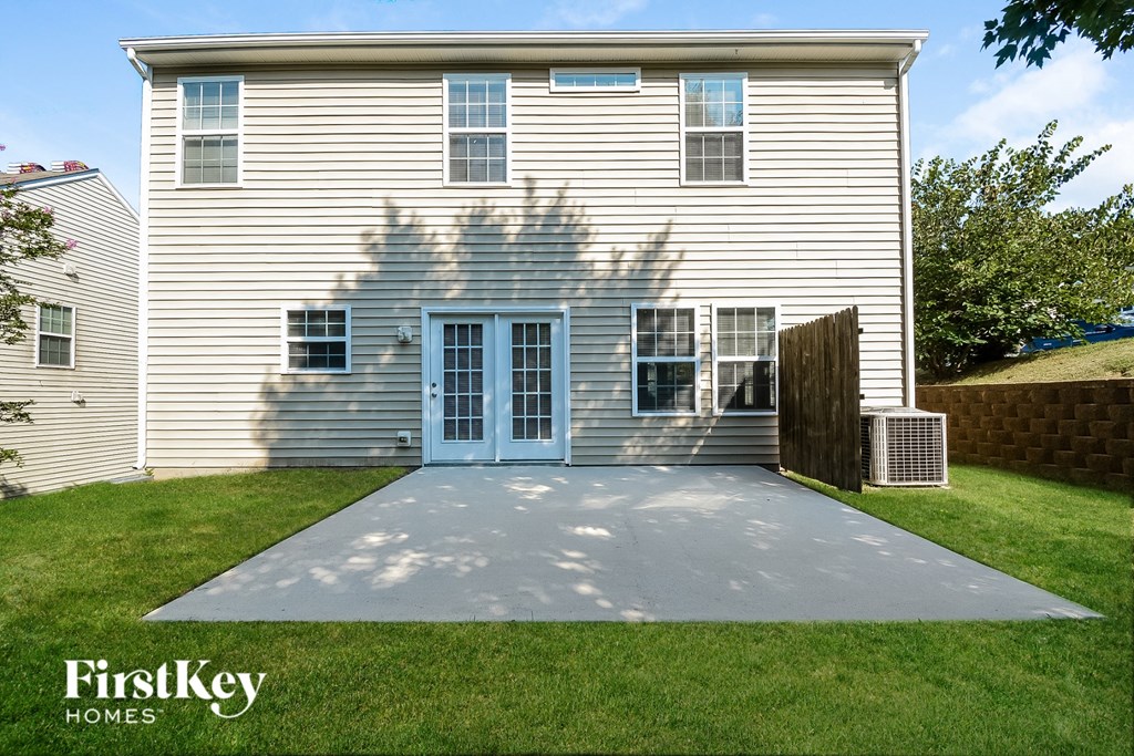 a concrete driveway in front of a white house