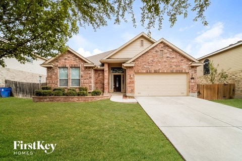 a brick house with a driveway and a garage door