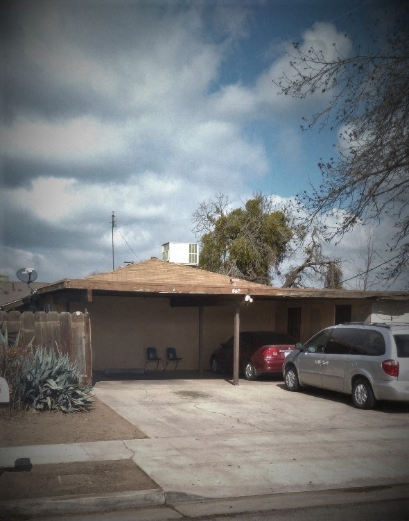 a house with cars parked in front of it