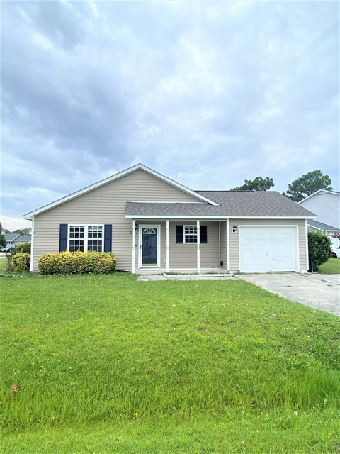 A house with a grey roof and a white garage door.