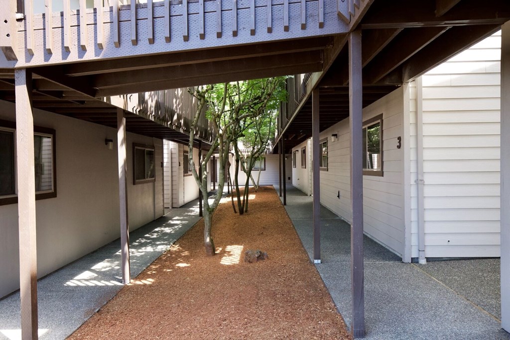 A long hallway with a tree in the middle.
