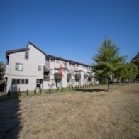 A white building with a red logo on it.